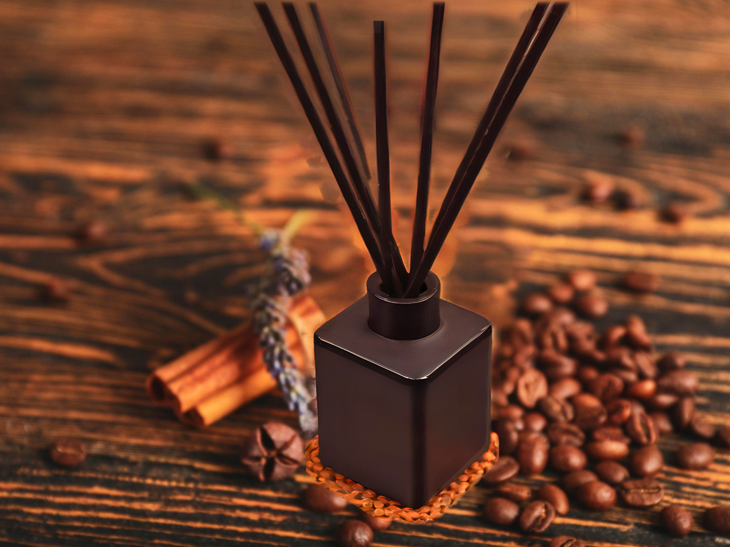 A modern living room featuring a 2 cushion gray-blue couch, a lamp hanging over an end table, and a lamp on a modern tripod stand. Dark blue walls and geometric triangle patterned rug.